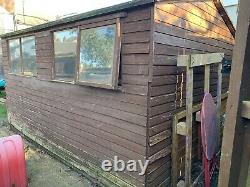 USED Wooden Garden Shed 12' x 8'. Workbench and Shelving Inside. Two Windows