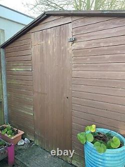 USED Wooden Garden Shed 12' x 8'. Workbench and Shelving Inside. Two Windows
